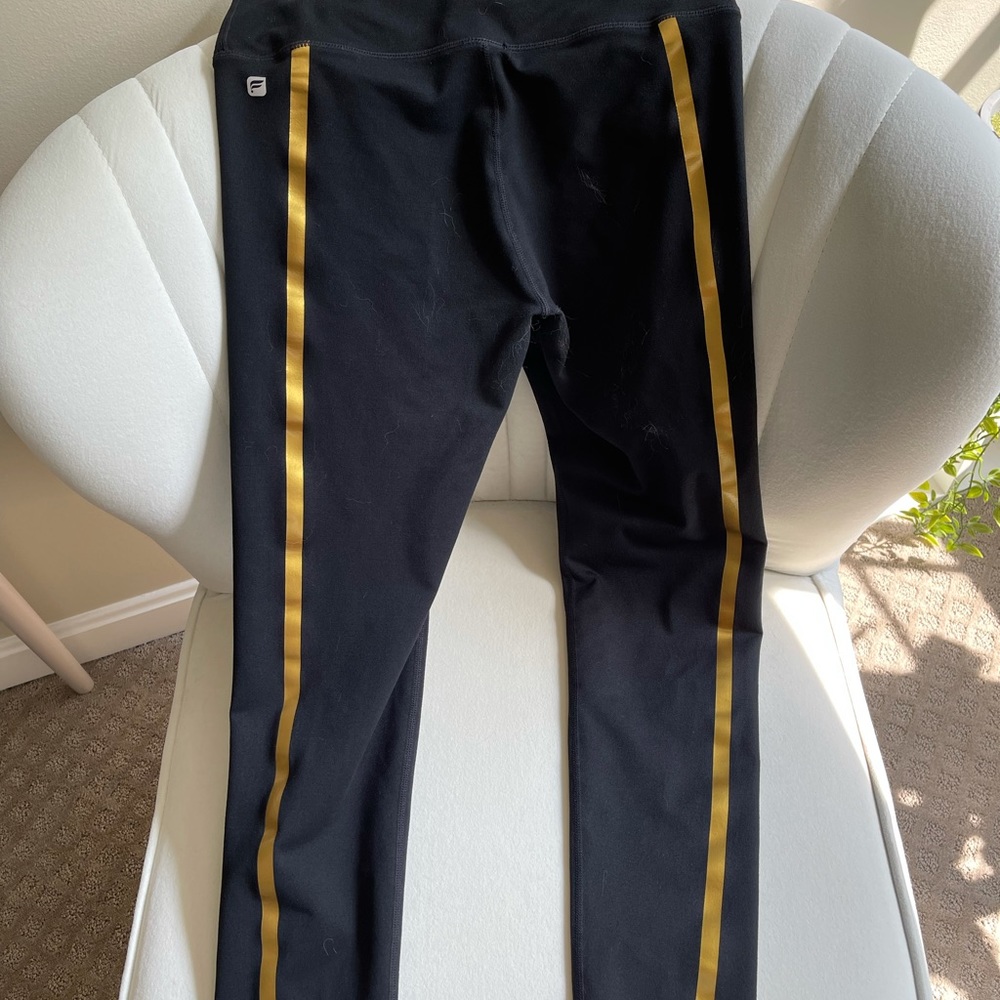 Fabletics black leggings with gold stripe